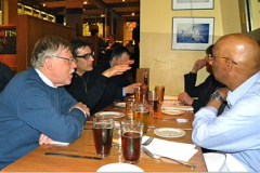 Marcello Papini gestures while Somuri Prasad, John Williams, Alfons Fischer and Cris Shwartz look on at the 2013 WOM Editorial Committee Dinner